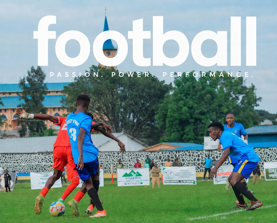 Two football players challenging for the ball in front of a stand and a church spire