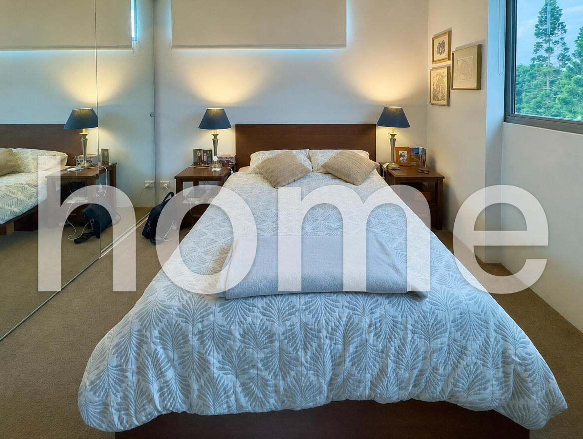 Bedroom with a patterned white bedspread and bedside lamps