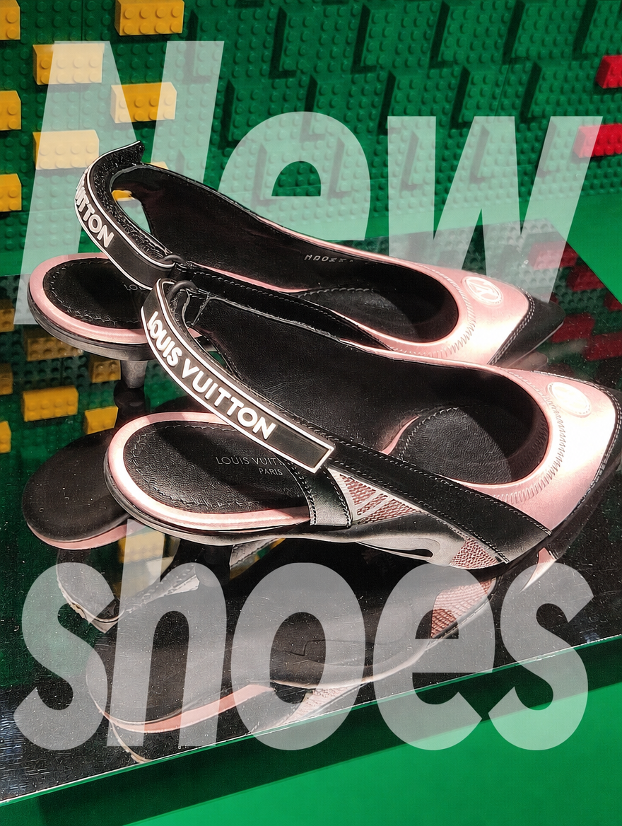 Pair of branded slingback shoes on a mirrored stand against green bricks